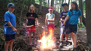 roasting hotdogs for lunch at camp
