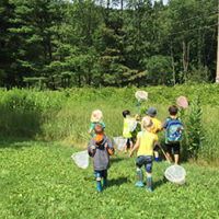 kids heading out with bug nets into field