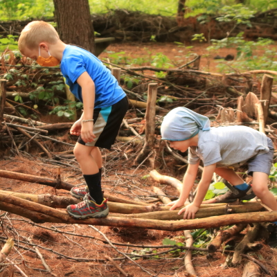 young children balance crossing log
