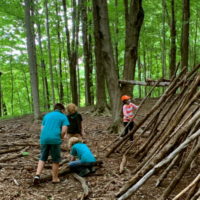 fort building at summer camp kids with sticks