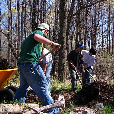 volunteers lay dirt along the trail