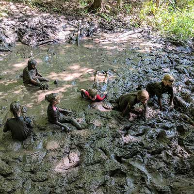 camp group in swamp at baltimore woods covered in mud