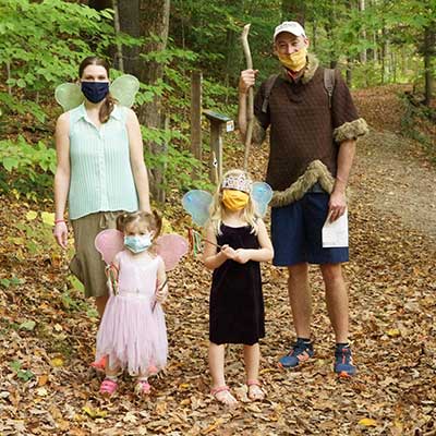 family of fairy festival goers along the trail of Baltimore Woods