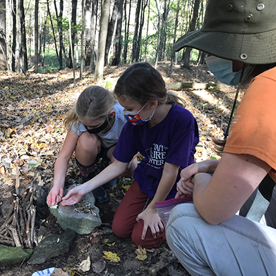 Science Adventures in Nature participants learning how to build a fire.