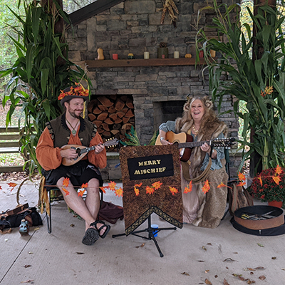 Participants of the Autumnal Fairy Festival at Baltimore Woods playing music for festival goers.