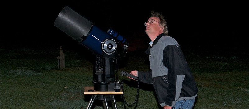 Star Party participant using a telescope.