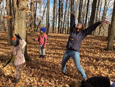 Throwing fall leaves in the forest