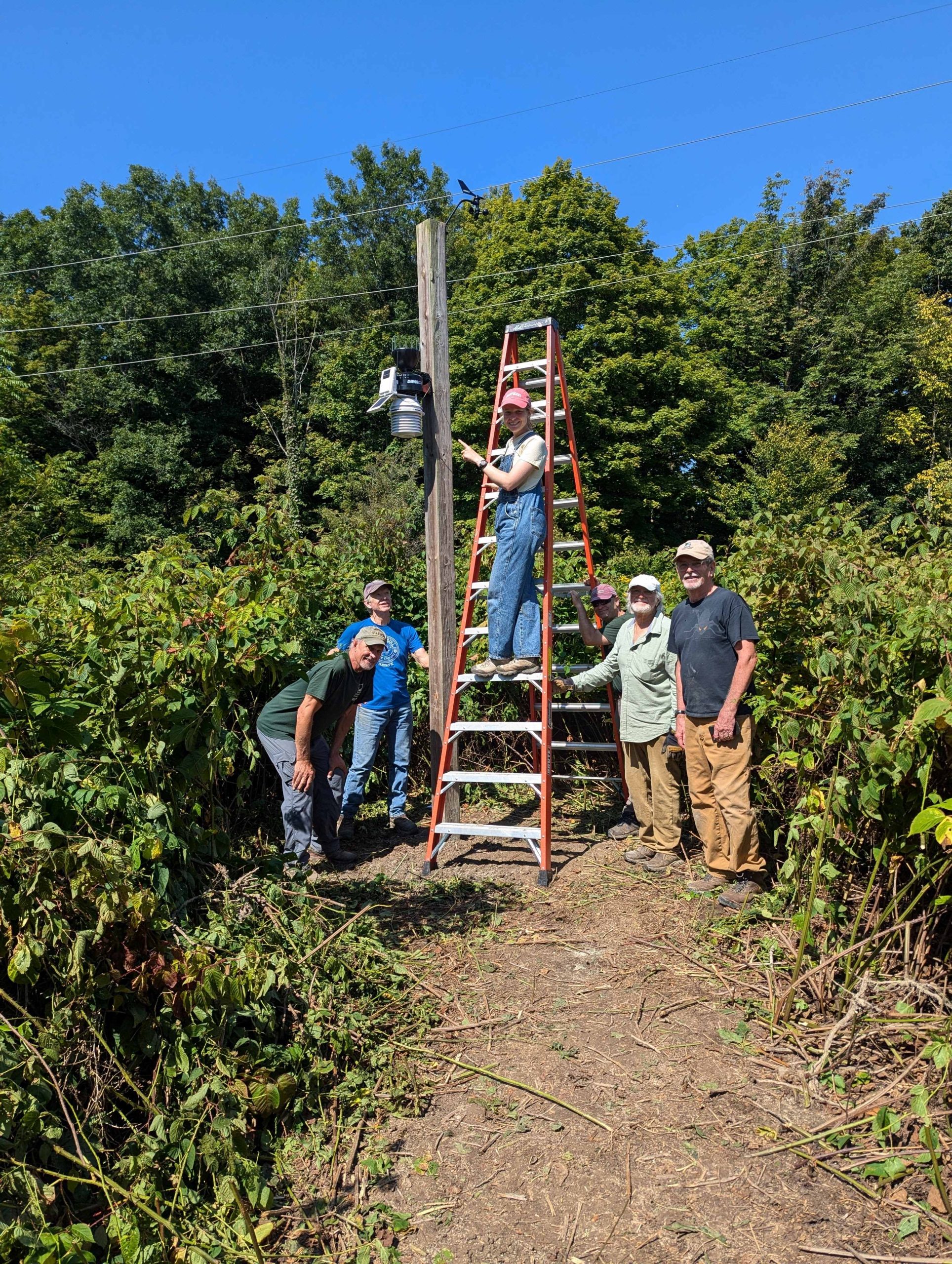 Staff and volunteers at Baltimore Woods working to get the weather station installed.