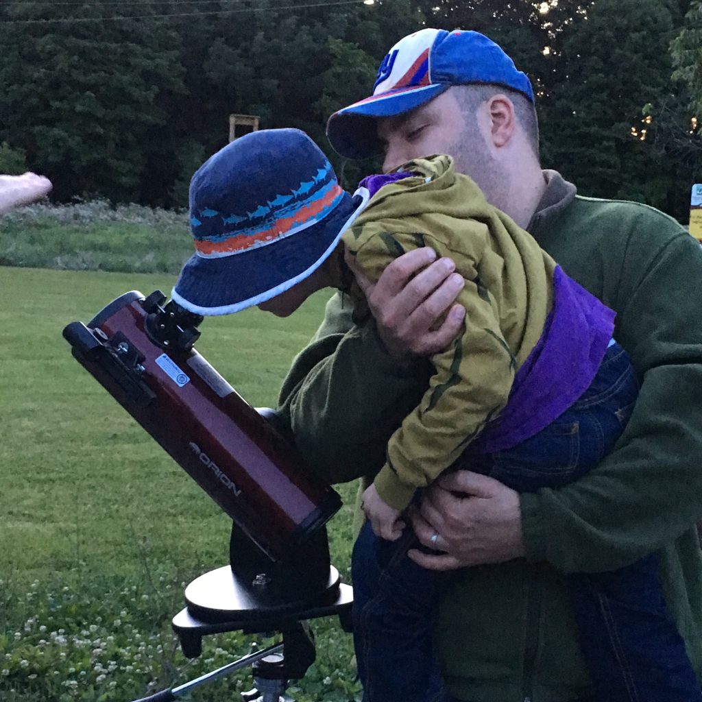 Star Party participants at Baltimore Woods looking through a telescope.