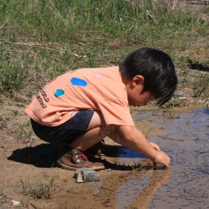 NLE participant playing in the stream at Baltimore Woods.