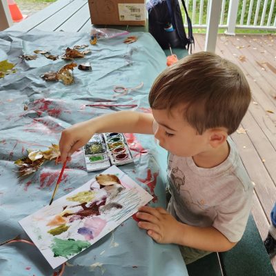 NLE participant painting fall leaves at Baltimore Woods.