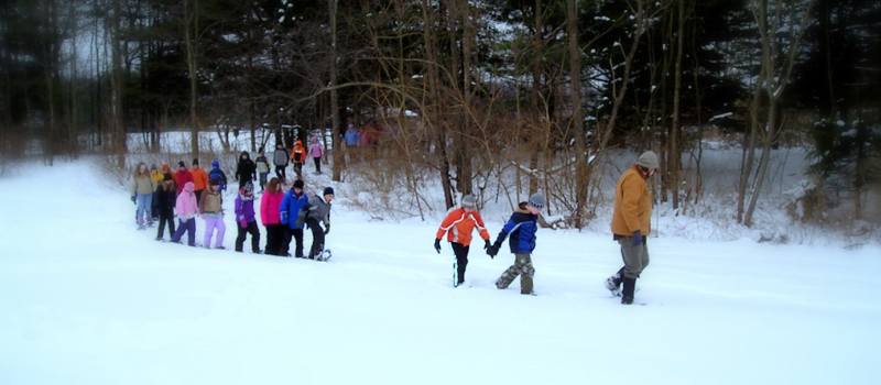 Group of children snowshoeing