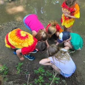 Campers Gathered around discovery on streambank_400x400